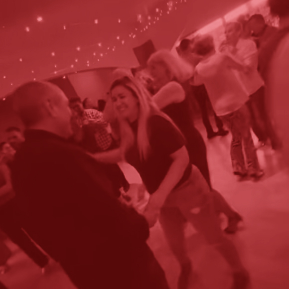 Couples dancing under warm fairy lights at a Salsa Belfast social