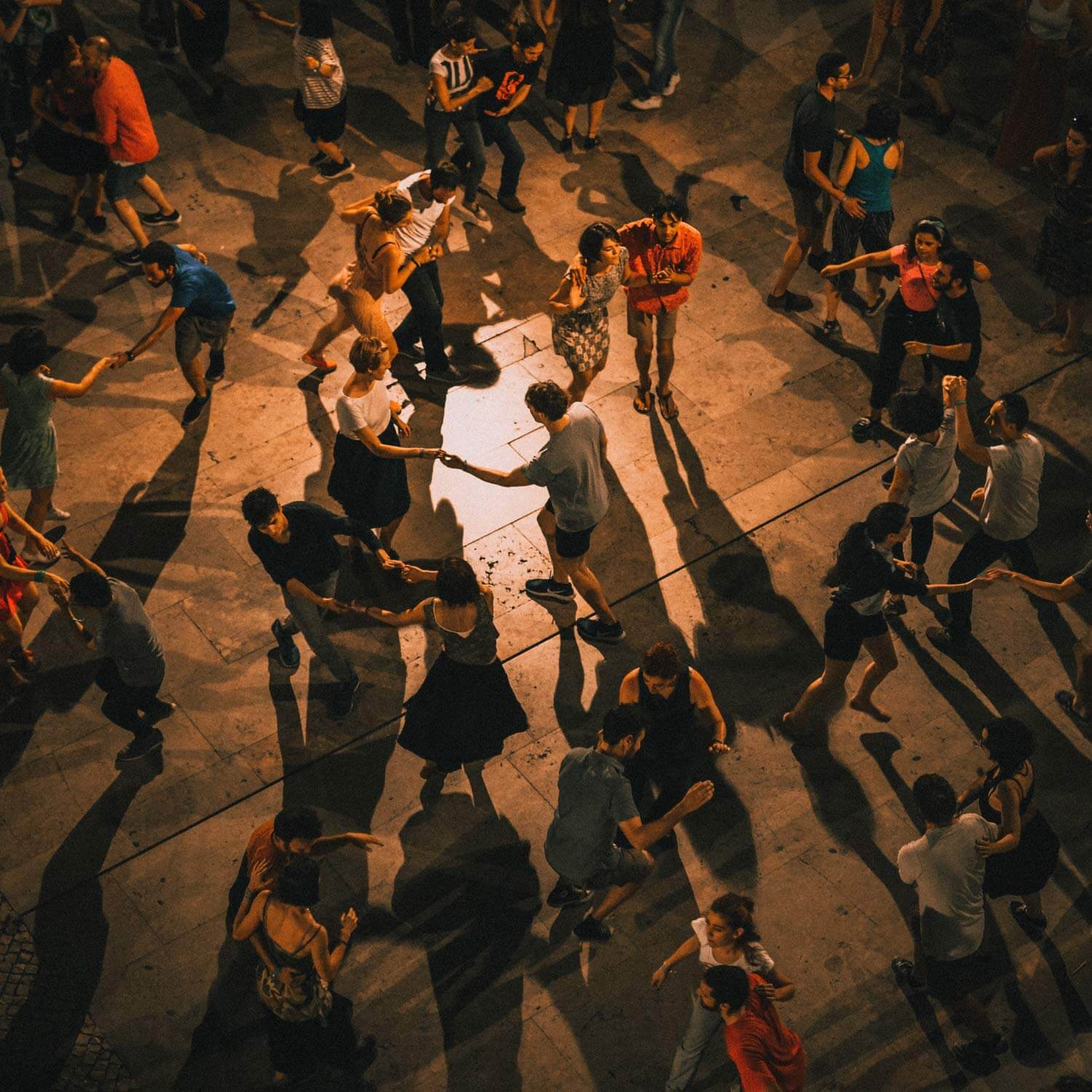 Overhead shot of a large outdoor salsa social at night